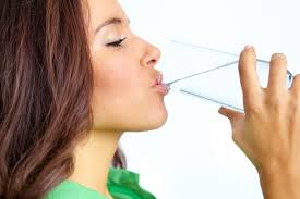 woman drinking a glass of water