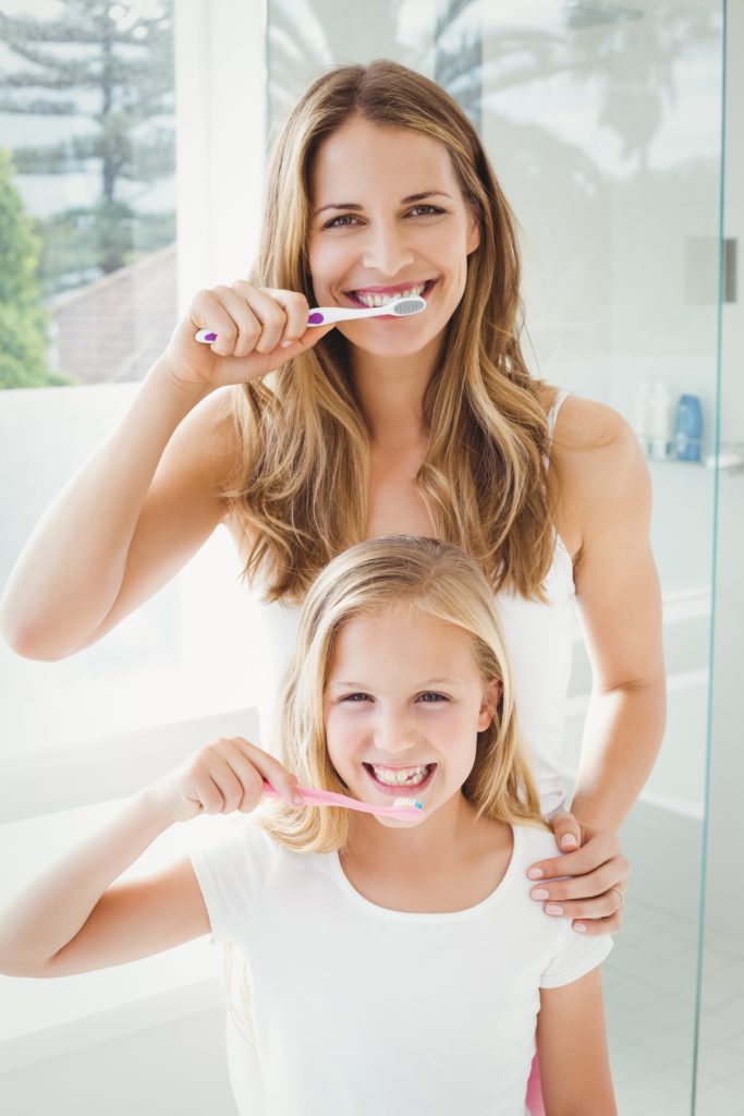 Midtown Pediatric Dentistand daughter brushing teeth