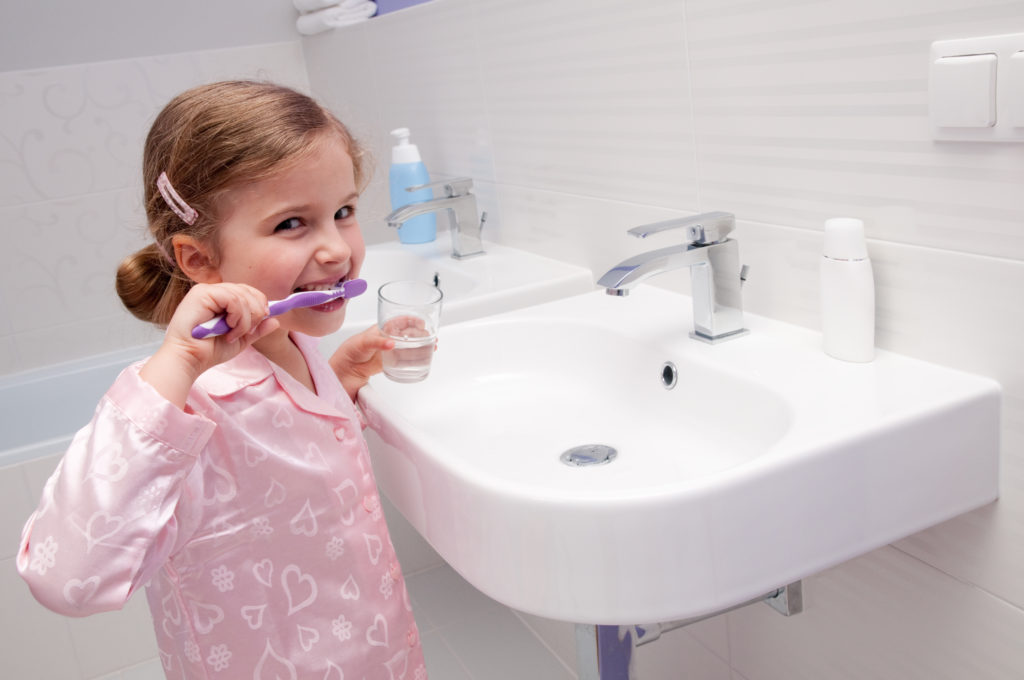 girl brushing her teeth