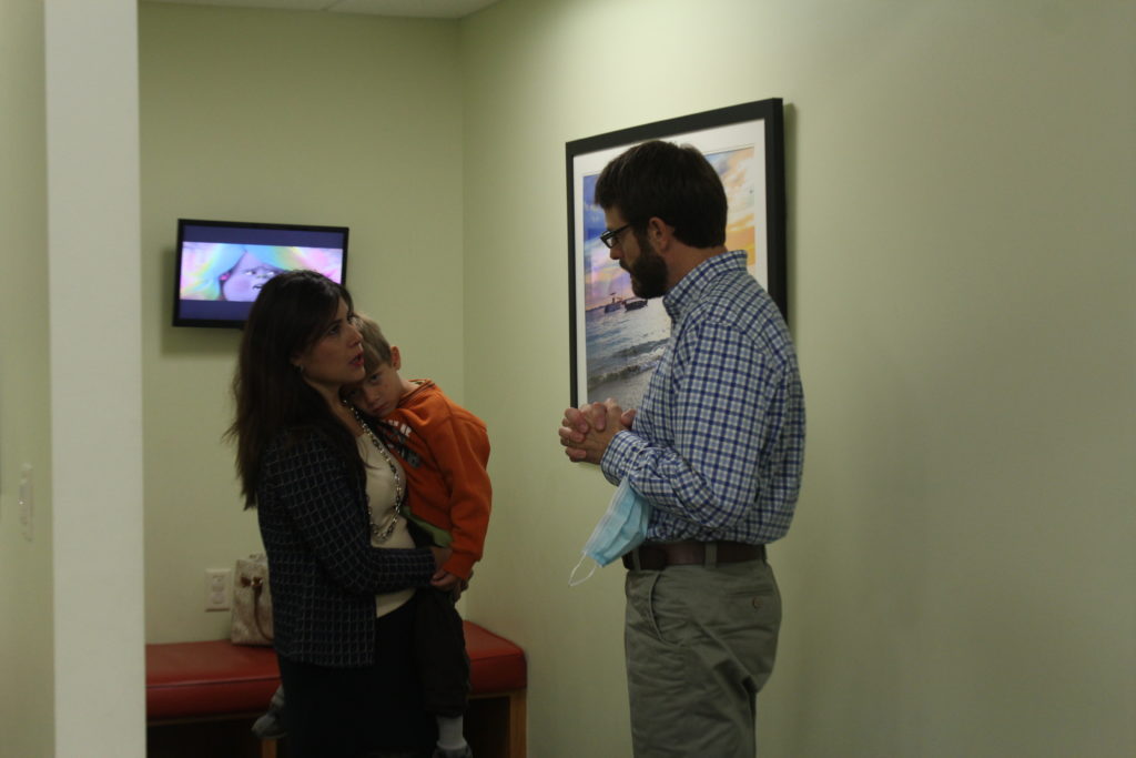 Doctor talking with a patient and her son