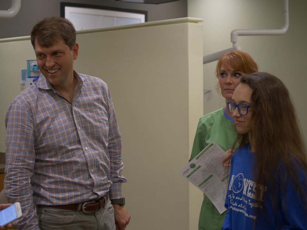 Patient talking with a doctor and staff