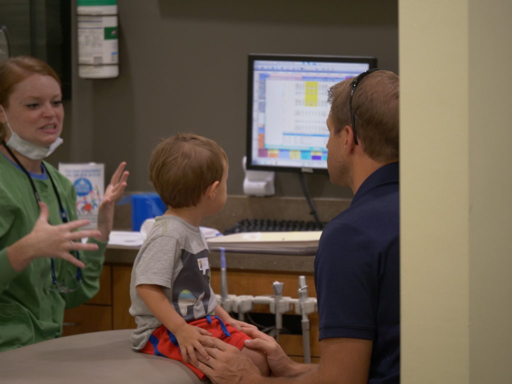 Children's Dental Center staff talking with a family