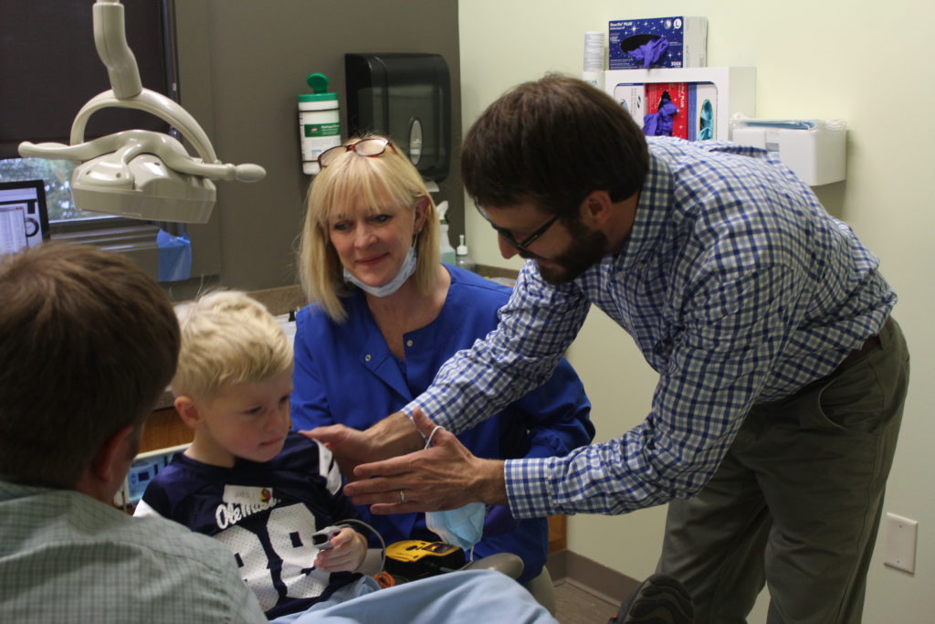 doctor talking to a boy about his teeth