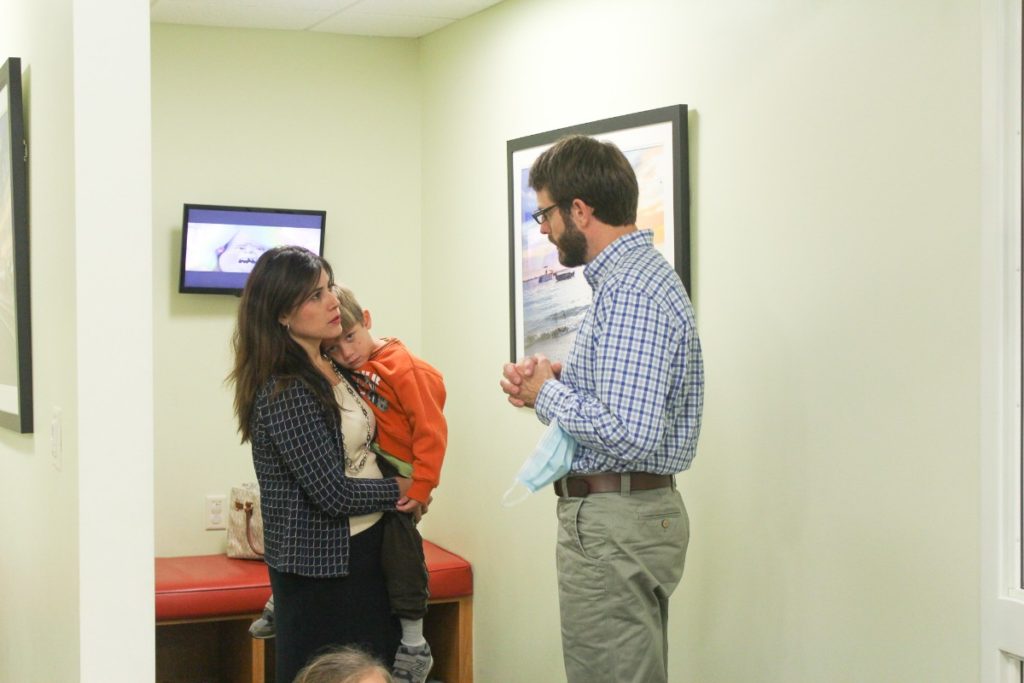 Dentist at Children's Dental Center and child patient with his mom